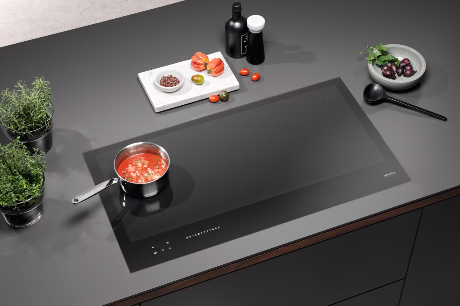 Bếp từ Miele thiết kế tối giản, mặt kính Schott Ceran đen bóng, lắp âm liền mạch, tôn vẻ đẹp sang trọng.